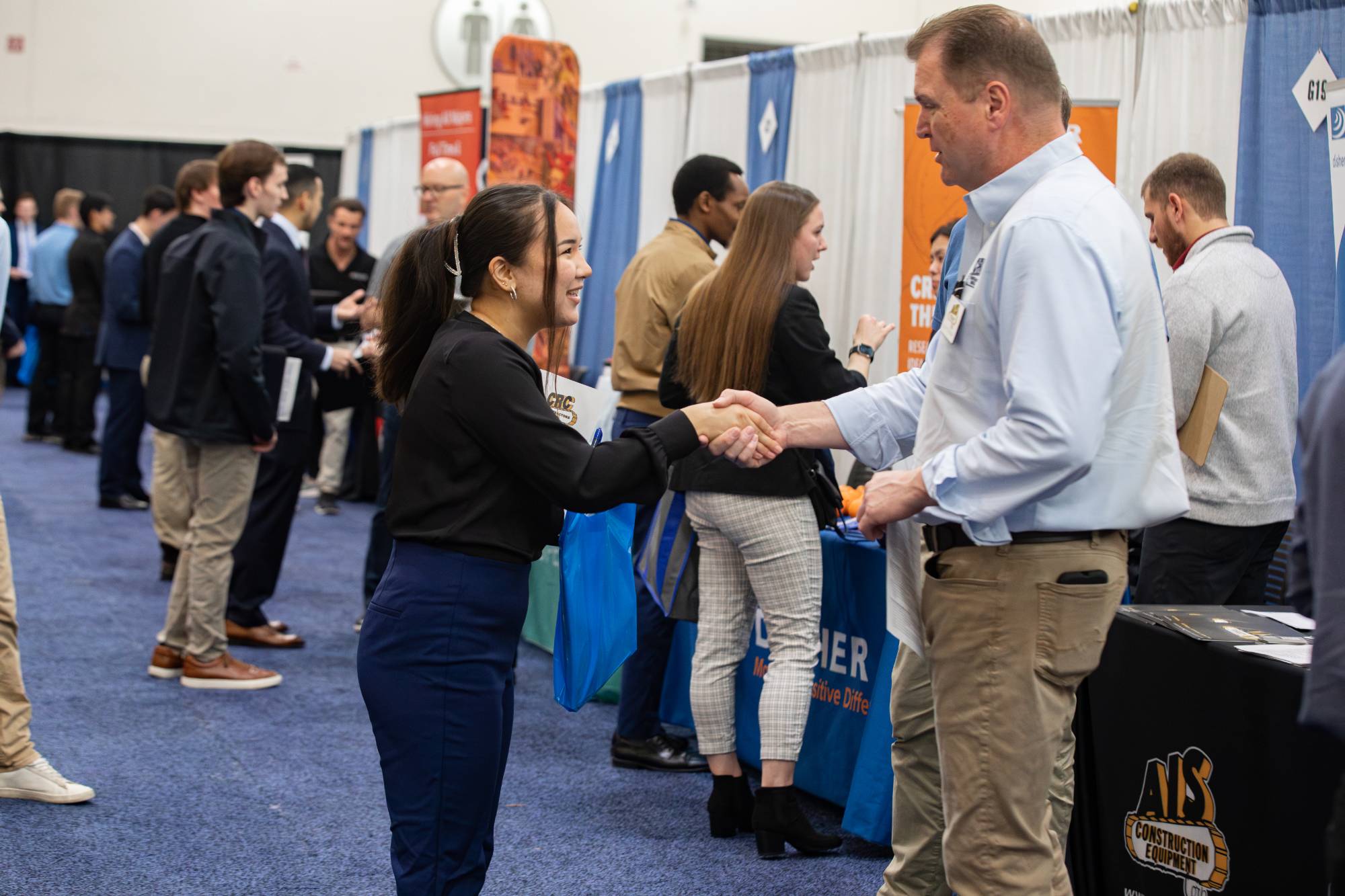 employer and student shaking hands at career fair